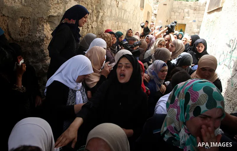 Relatives of 21-year-old Saad Salah mourn during the funeral of Saad and 17-year-old Aws Salame, who were shot dead during clashes with the Israeli security forces in the West Bank city of Jenin, on July 12, 2017. Photo...