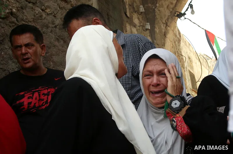 Relatives of 21-year-old Saad Salah mourn during the funeral of Saad and 17-year-old Aws Salame, who were shot dead during clashes with the Israeli security forces in the West Bank city of Jenin, on July 12, 2017. Photo...