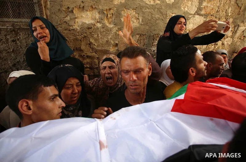 Palestinian mourners carry the body of 21-year-old Saad Salah during a funeral for Saad and 17-year-old Aws Salame, who were shot dead during clashes with the Israeli security forces in the West Bank city of Jenin, on Ju...