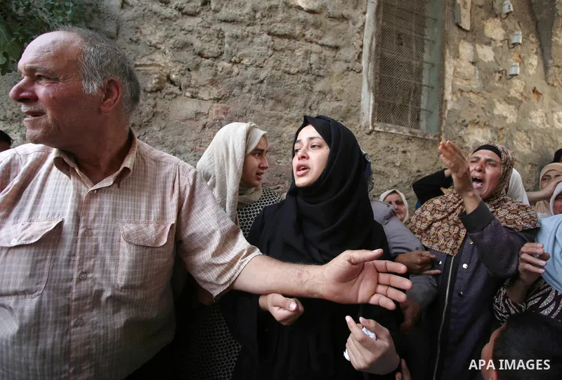 Relatives of 21-year-old Saad Salah mourn during the funeral of Saad and 17-year-old Aws Salame, who were shot dead during clashes with the Israeli security forces in the West Bank city of Jenin, on July 12, 2017. Photo...