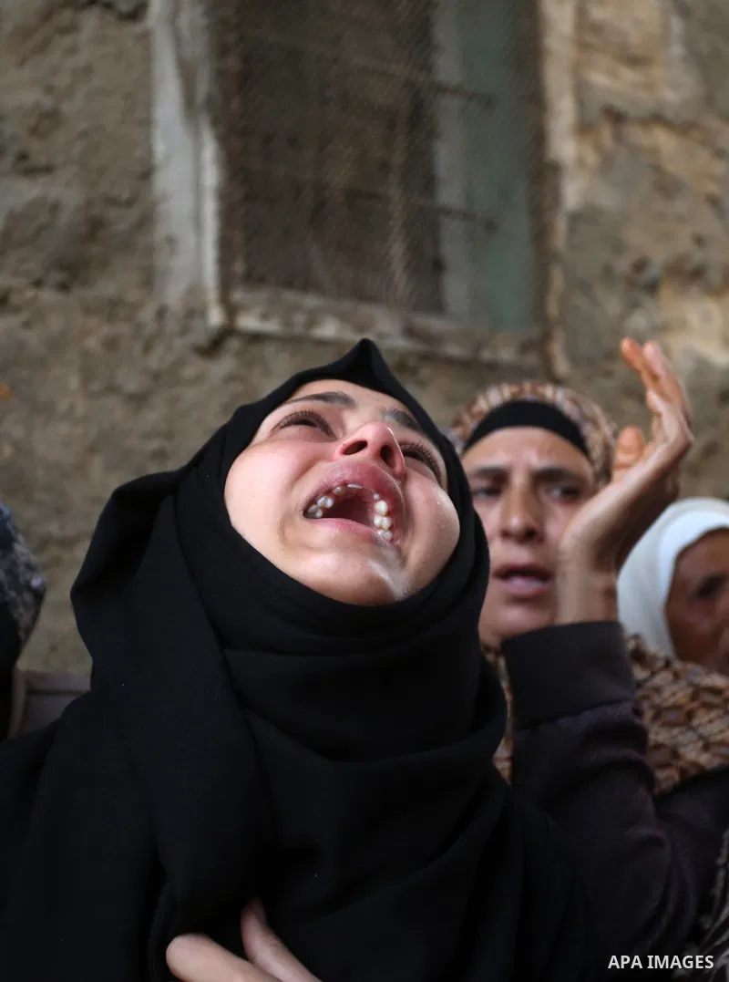 Relatives of 21-year-old Saad Salah mourn during the funeral of Saad and 17-year-old Aws Salame, who were shot dead during clashes with the Israeli security forces in the West Bank city of Jenin, on July 12, 2017. Photo...