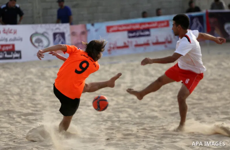 Palestinian Shabab Khan Younis players and al-Jalaa players compete for ball during the beach soccer (football) final match, in Gaza city on July 12, 2017. Photo by Mohammed Asad
