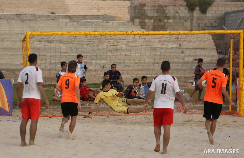 Palestinian Shabab Khan Younis players and al-Jalaa players compete for ball during the beach soccer (football) final match, in Gaza city on July 12, 2017. Photo by Mohammed Asad