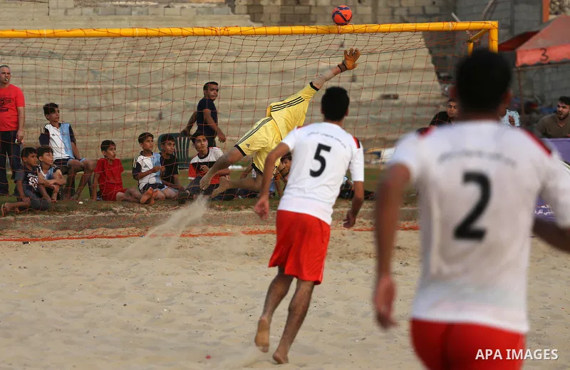 Palestinian Shabab Khan Younis players and al-Jalaa players compete for ball during the beach soccer (football) final match, in Gaza city on July 12, 2017. Photo by Mohammed Asad