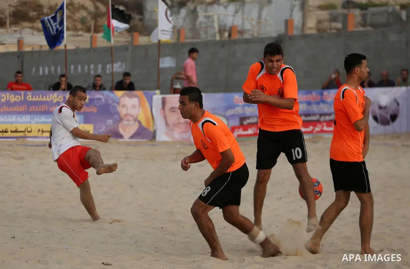 Palestinian Shabab Khan Younis players and al-Jalaa players compete for ball during the beach soccer (football) final match, in Gaza city on July 12, 2017. Photo by Mohammed Asad