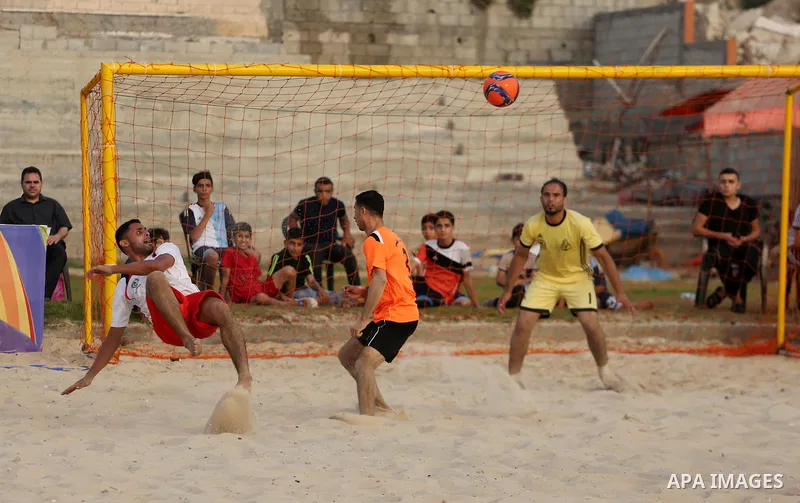 Palestinian Shabab Khan Younis players and al-Jalaa players compete for ball during the beach soccer (football) final match, in Gaza city on July 12, 2017. Photo by Mohammed Asad