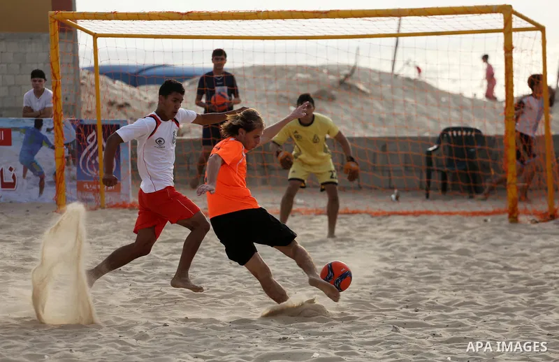 Palestinian Shabab Khan Younis players and al-Jalaa players compete for ball during the beach soccer (football) final match, in Gaza city on July 12, 2017. Photo by Mohammed Asad