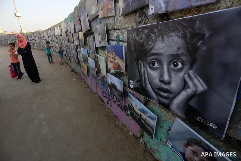 Palestinians take part in a photo exhibition called " A Thousand Pictures From Besieged City" at Gaza seaport in Gaza City on July 13, 2017. Photo by Mohammed Asad