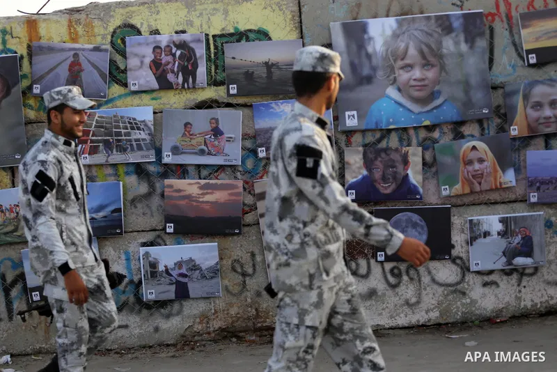 Palestinians take part in a photo exhibition called " A Thousand Pictures From Besieged City" at Gaza seaport in Gaza City on July 13, 2017. Photo by Mohammed Asad
