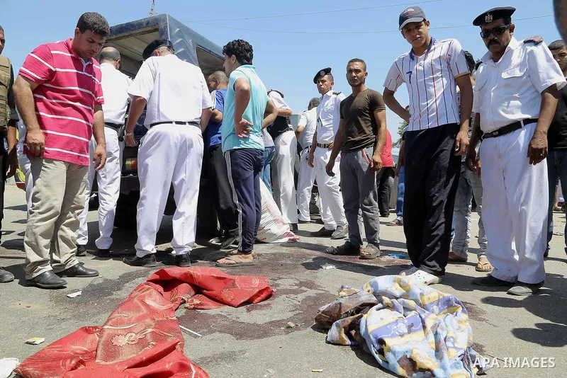 Egyptian policemen inspect the scene of an attack which left five of their colleagues killed in a shooting near Badrasheen, a town some 20 kilometres (12 miles) from Cairo where militants have also targeted security forc...