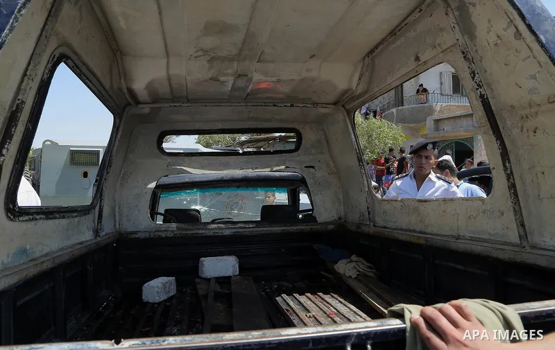 Egyptian policemen inspect the scene of an attack which left five of their colleagues killed in a shooting near Badrasheen, a town some 20 kilometres (12 miles) from Cairo where militants have also targeted security forc...