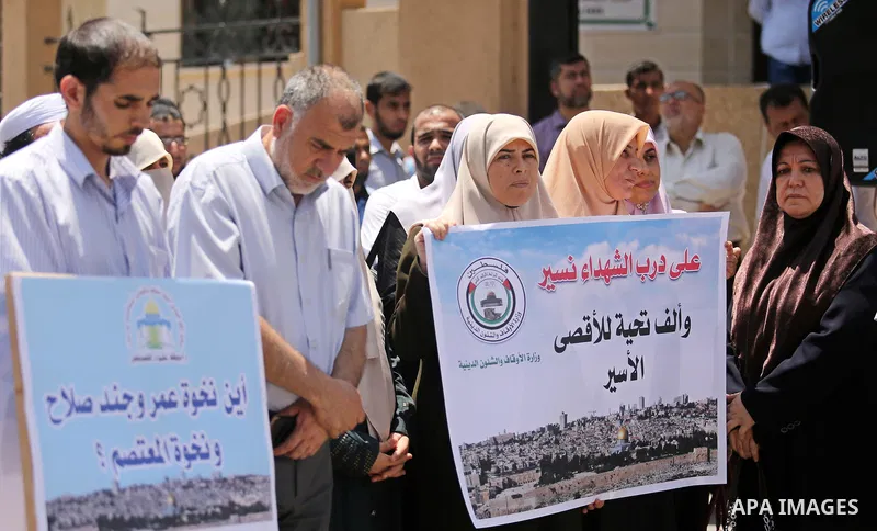 Members of the Palestine Scholars Association take part in a protest against the recent closure of the Al-Aqsa Mosque compound by Israel, in Gaza City on July 16, 2017. Photo by Ashraf Amra