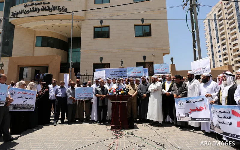 Members of the Palestine Scholars Association take part in a protest against the recent closure of the Al-Aqsa Mosque compound by Israel, in Gaza City on July 16, 2017. Photo by Ashraf Amra