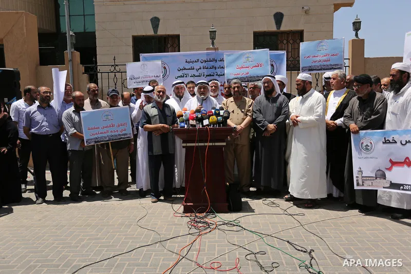 Members of the Palestine Scholars Association take part in a protest against the recent closure of the Al-Aqsa Mosque compound by Israel, in Gaza City on July 16, 2017. Photo by Ashraf Amra