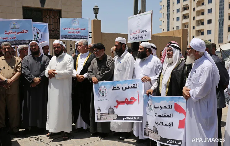 Members of the Palestine Scholars Association take part in a protest against the recent closure of the Al-Aqsa Mosque compound by Israel, in Gaza City on July 16, 2017. Photo by Ashraf Amra