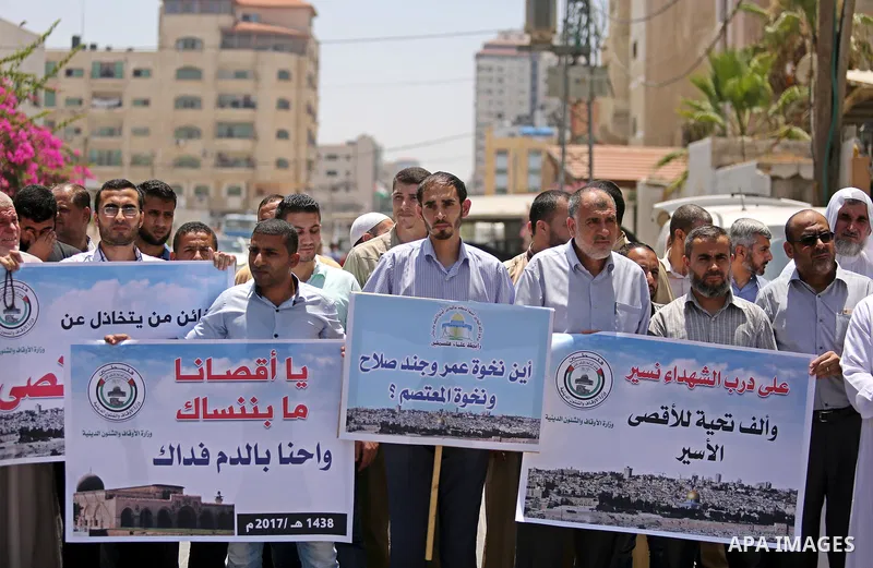 Members of the Palestine Scholars Association take part in a protest against the recent closure of the Al-Aqsa Mosque compound by Israel, in Gaza City on July 16, 2017. Photo by Ashraf Amra