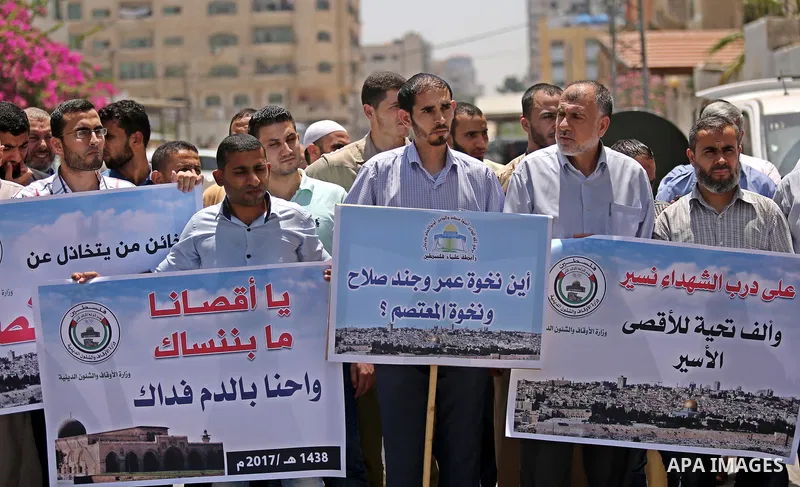Members of the Palestine Scholars Association take part in a protest against the recent closure of the Al-Aqsa Mosque compound by Israel, in Gaza City on July 16, 2017. Photo by Ashraf Amra