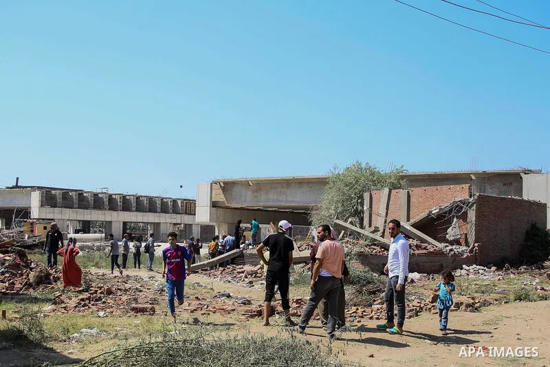 Egyptians gather during the operations of removal of illegal buildings which built on the state lands in the Warraq district of Giza, southwest of Cairo, Egypt, on July 16, 2017. Photo by Amr Sayed