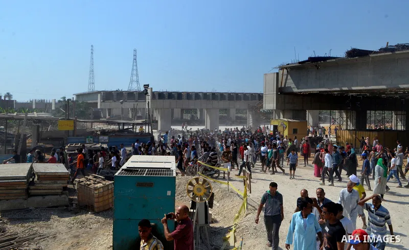 Egyptians gather during the operations of removal of illegal buildings which built on the state lands in the Warraq district of Giza, southwest of Cairo, Egypt, on July 16, 2017. Photo by Amr Sayed