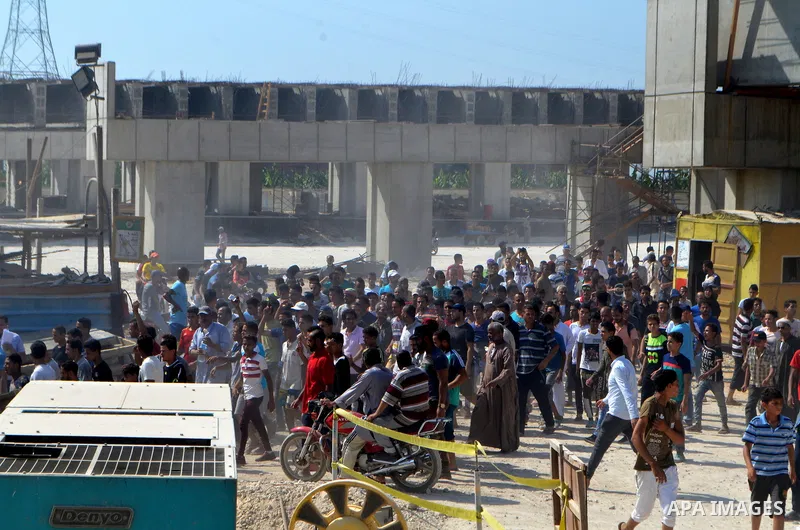 Egyptians gather during the operations of removal of illegal buildings which built on the state lands in the Warraq district of Giza, southwest of Cairo, Egypt, on July 16, 2017. Photo by Amr Sayed
