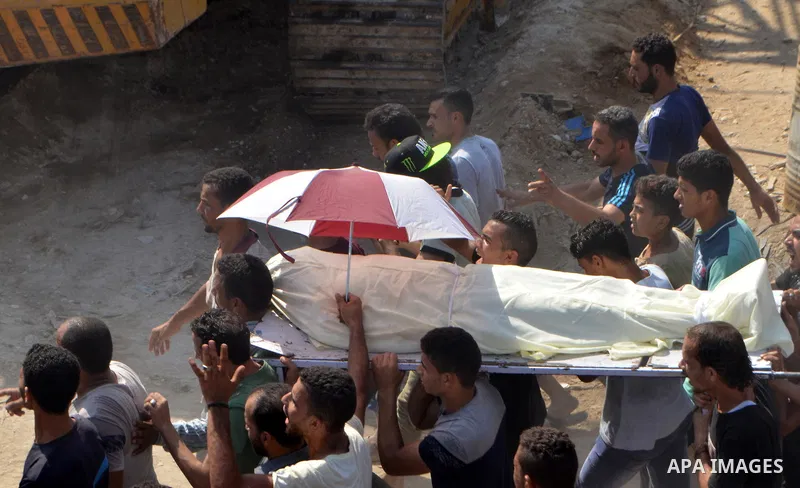 Egyptians carry the body of Sayed Tafshan, who died during clashes between Egyptians security forces and residents in the Warraq district of Giza, southwest of Cairo, Egypt, on July 16, 2017. Egypt's Health Ministry said...