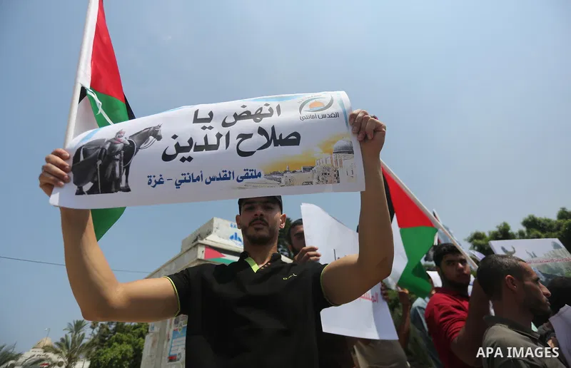 Palestinians take part in a protest against the recent closure of the Al-Aqsa Mosque compound by Israel, in Gaza City on July 17, 2017. Photo by Mohammed Asad
