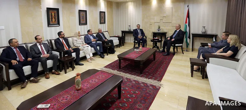 Palestinian Prime Minister, Rami Hamdallah, receives the report of the Bureau of Financial and Administrative Control for the year 2016, in the West Bank city of Ramallah, on July 17, 2017. Photo by Prime Minister Office