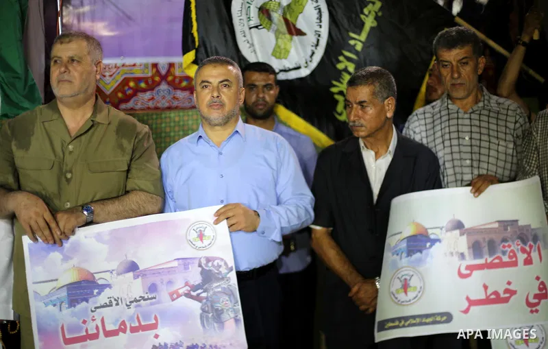 Palestinian supporters of Hamas movement and Islamic Jihad take part in a protest against the recent closure of the Al-Aqsa Mosque compound by Israel, in Gaza City on July 17, 2017. Photo by Mohammed Asad