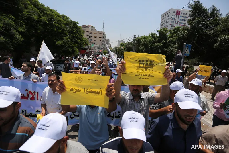 Palestinians take part in a protest against the recent closure of the Al-Aqsa Mosque compound by Israel and Israeli blockade on Gaza strip, in Gaza City on July 18, 2017. Photo by Ashraf Amra