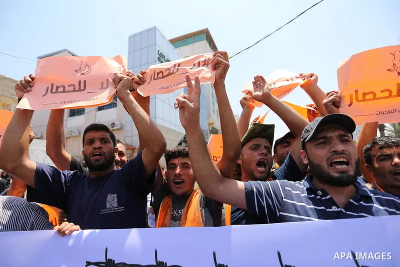 Palestinians take part in a protest against the recent closure of the Al-Aqsa Mosque compound by Israel and Israeli blockade on Gaza strip, in Gaza City on July 18, 2017. Photo by Ashraf Amra