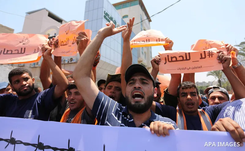Palestinians take part in a protest against the recent closure of the Al-Aqsa Mosque compound by Israel and Israeli blockade on Gaza strip, in Gaza City on July 18, 2017. Photo by Ashraf Amra