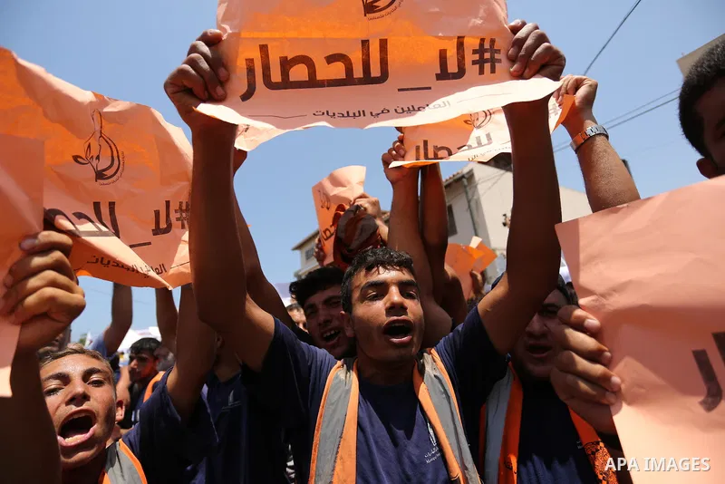 Palestinians take part in a protest against the recent closure of the Al-Aqsa Mosque compound by Israel and Israeli blockade on Gaza strip, in Gaza City on July 18, 2017. Photo by Ashraf Amra