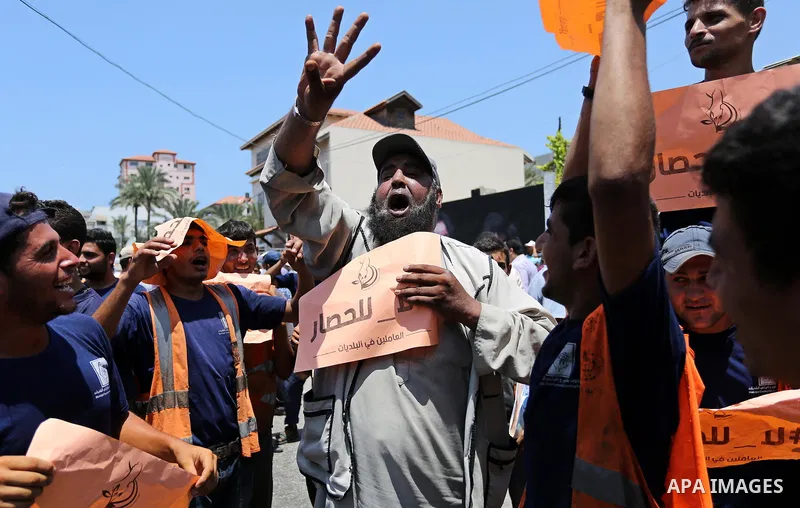 Palestinians take part in a protest against the recent closure of the Al-Aqsa Mosque compound by Israel and Israeli blockade on Gaza strip, in Gaza City on July 18, 2017. Photo by Ashraf Amra