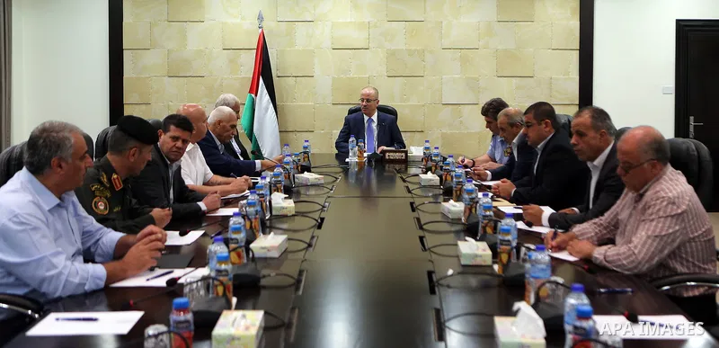 Palestinian Prime Minister Rami Hamdallah chairs a meeting with security chiefs at his office, in the West Bank city of Ramallah on July 18, 2017. Photo by Prime Minister Office