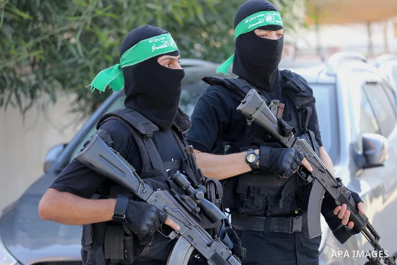 Palestinian militants from different local factions hold their weapons during a press conference to refuse closure of the Al-Aqsa Mosque compound by Israel in Gaza City on July 18, 2017. Photo by Mohammed Asad