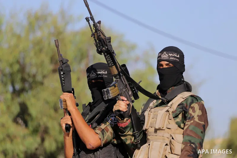 Palestinian militants from different local factions hold their weapons during a press conference to refuse closure of the Al-Aqsa Mosque compound by Israel in Gaza City on July 18, 2017. Photo by Mohammed Asad