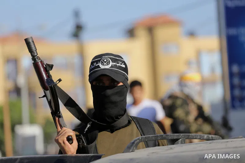 Palestinian militants from different local factions hold their weapons during a press conference to refuse closure of the Al-Aqsa Mosque compound by Israel in Gaza City on July 18, 2017. Photo by Mohammed Asad