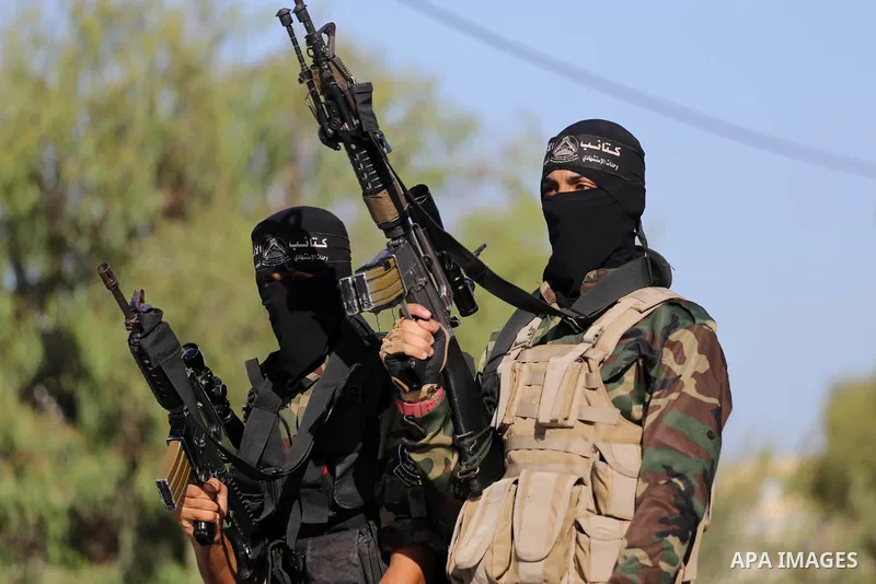 Palestinian militants from different local factions hold their weapons during a press conference to refuse closure of the Al-Aqsa Mosque compound by Israel in Gaza City on July 18, 2017. Photo by Mohammed Asad
