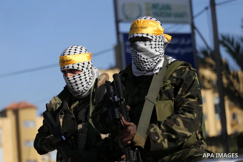 Palestinian militants from different local factions hold their weapons during a press conference to refuse closure of the Al-Aqsa Mosque compound by Israel in Gaza City on July 18, 2017. Photo by Mohammed Asad