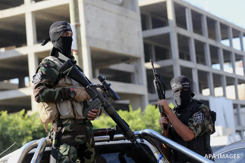 Palestinian militants from different local factions hold their weapons during a press conference to refuse closure of the Al-Aqsa Mosque compound by Israel in Gaza City on July 18, 2017. Photo by Mohammed Asad