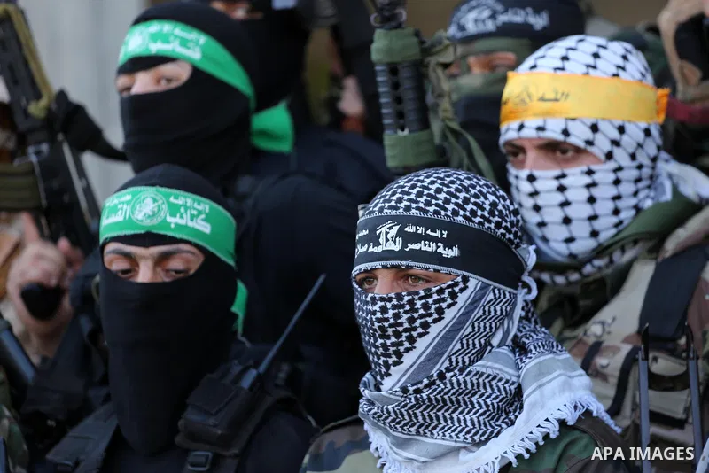 Palestinian militants from different local factions hold a press conference to refuse closure of the Al-Aqsa Mosque compound by Israel in Gaza City on July 18, 2017. Photo by Mohammed Asad