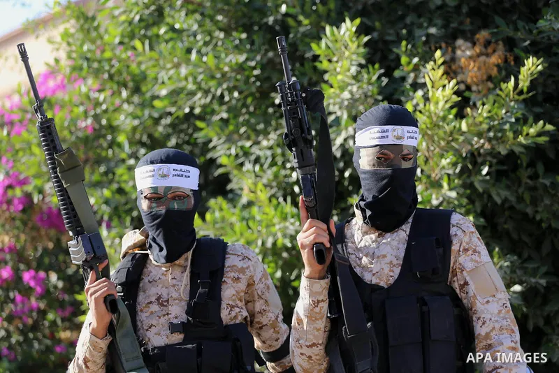Palestinian militants from different local factions hold their weapons during a press conference to refuse closure of the Al-Aqsa Mosque compound by Israel in Gaza City on July 18, 2017. Photo by Mohammed Asad