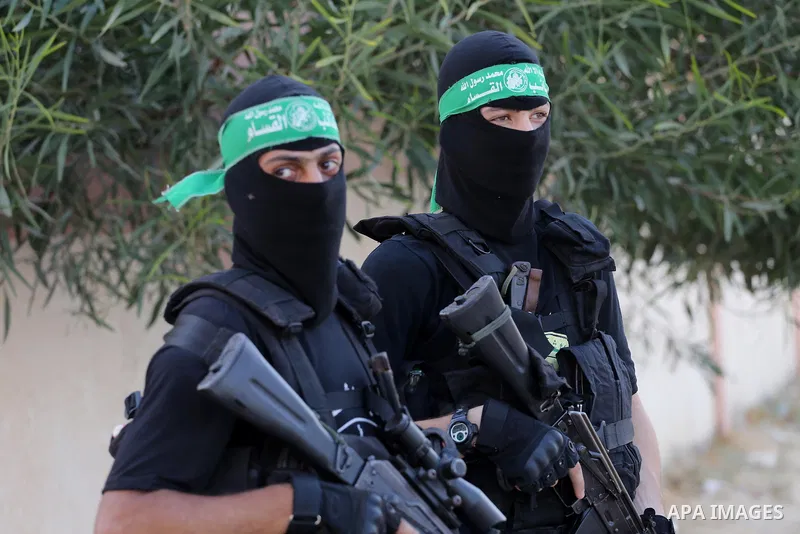 Palestinian militants from different local factions hold their weapons during a press conference to refuse closure of the Al-Aqsa Mosque compound by Israel in Gaza City on July 18, 2017. Photo by Mohammed Asad