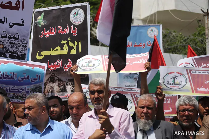 Palestinians take part in a protest against the recent closure of the Al-Aqsa Mosque compound by Israel, in Gaza City on July 19, 2017. Photo by Mohammed Asad