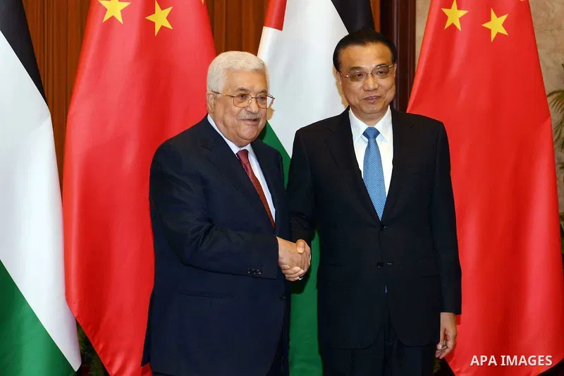 Palestinian President Mahmoud Abbas shakes hands with Chinese Prime Minister Li Keqiang before a meeting, in Beijing, China, on July 19, 2017. Abbas is on an official visit to China from July 17-20. Photo by Thaer Ganaim
