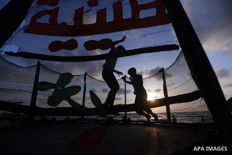 Palestinians enjoy their time at the beach of the Mediterranean sea on the coast of Gaza city on July 19, 2017. Photo by Yasser Qudih