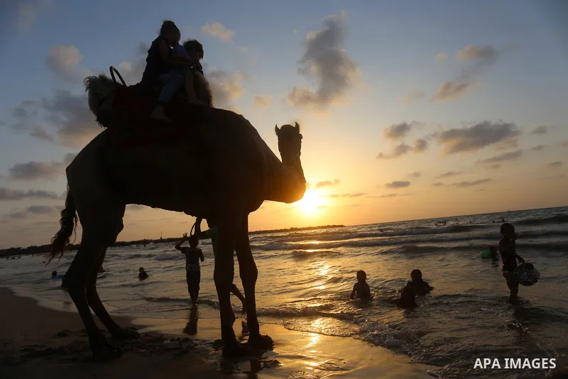 Palestinians enjoy their time at the beach of the Mediterranean sea on the coast of Gaza city on July 19, 2017. Photo by Yasser Qudih
