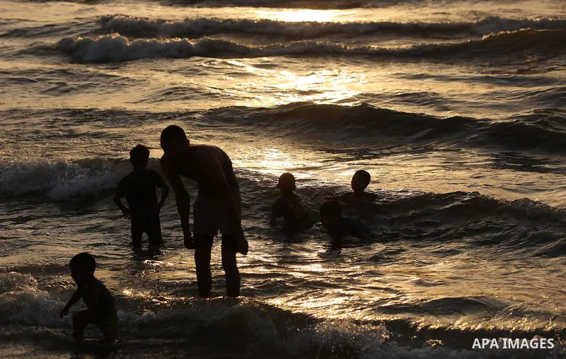 Palestinians swim in the Mediterranean sea on the coast of Gaza city on July 19, 2017. Photo by Yasser Qudih