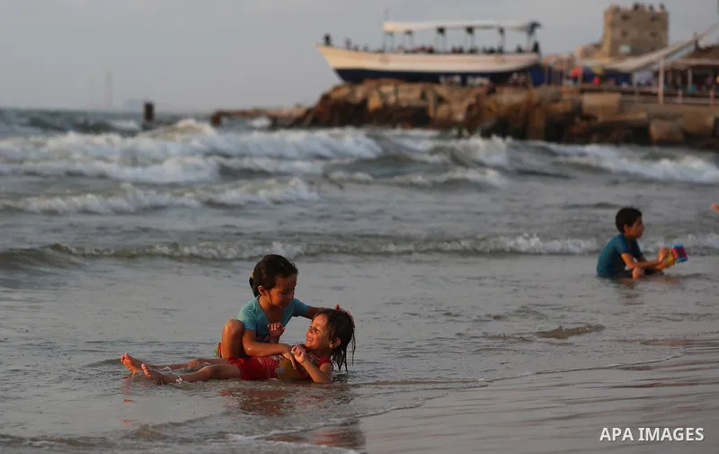 Palestinians swim in the Mediterranean sea on the coast of Gaza city on July 19, 2017. Photo by Yasser Qudih