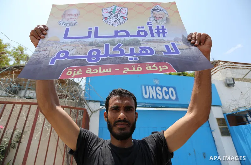 Palestinians Supporters of Fateh movement hold banners and march during a demonstration in Gaza City on July 20, 2017 against new Israeli security measures at Al-Aqsa mosque compound, which include metal detectors and ca...